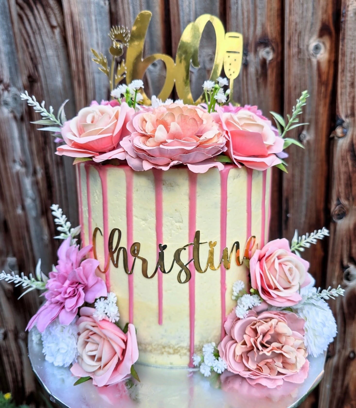 Roses, pink drips and a golden birthday topper.