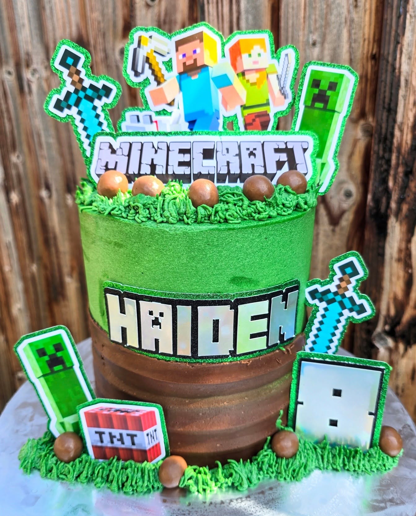 A Minecraft design with green grass, characters and blocky details.