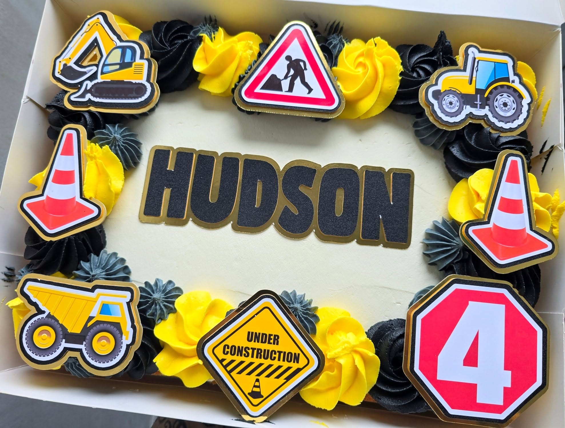 Diggers, signs and a colourful construction-themed birthday cake.