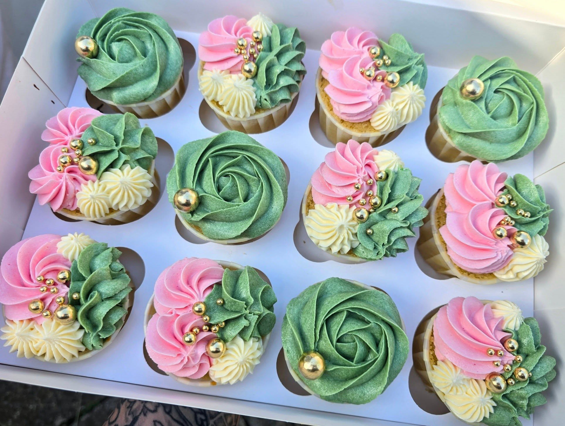 Green, pink and cream swirls with floral piping.